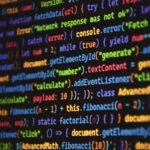 Close-up of vibrant colored JavaScript code showing functions and syntax on a dark screen.